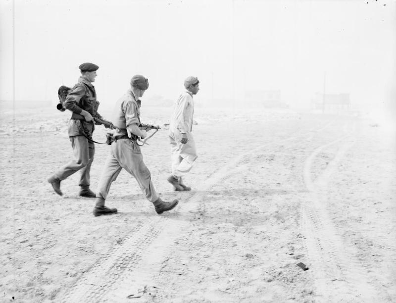 troops_of_3rd_battalion_parachute_regiment_escort_a_captured_egyptian_soldier_on_the_beach_at_port_said.jpg