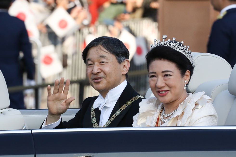 emperor-naruhito-and-empress-masako-wave-from-their-car-news-photo-1626804153.jpg
