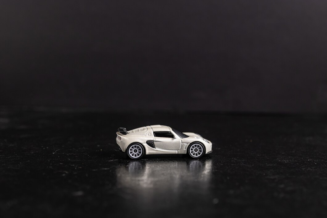 selective-focus-shot-white-toy-sports-car-black-surface_181624-17606.jpg