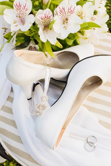 overhead-view-flowers-high-heels-crown-scarf-wedding-rings-table_23-2148187444.jpg