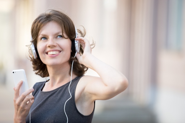 close-up-of-cheerful-woman-listening-to-music_1163-860.jpg