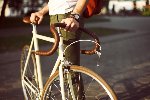 close-up-of-man-holding-his-white-bicycle_1140-18.jpg